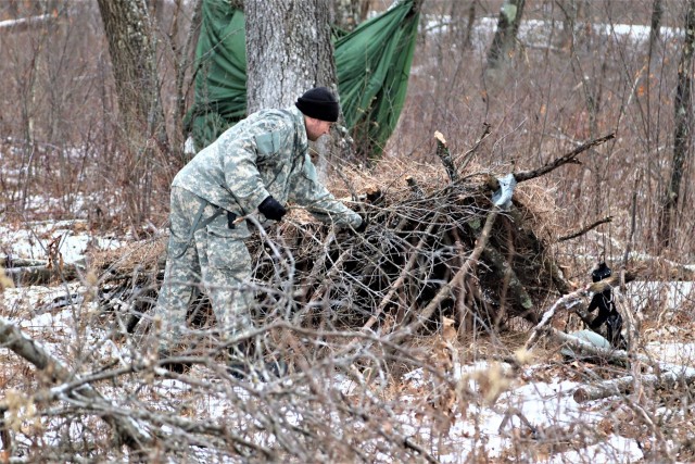 Cold-Weather Operations Course students build improvised shelters, survive outdoors