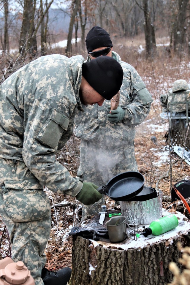 Cold-Weather Operations Course students build improvised shelters, survive outdoors