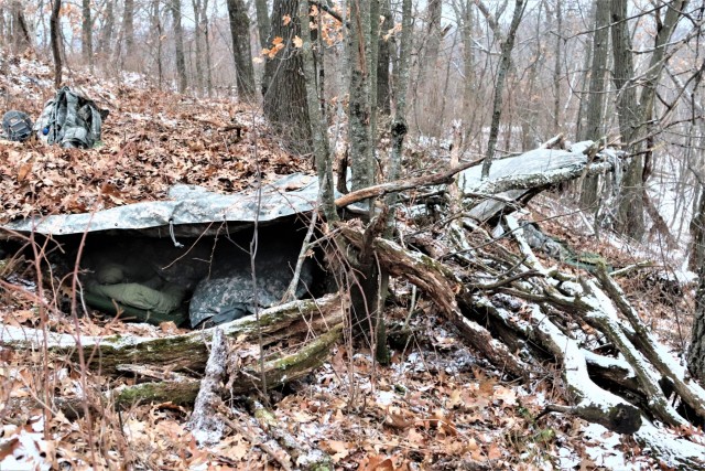 Cold-Weather Operations Course students build improvised shelters, survive outdoors