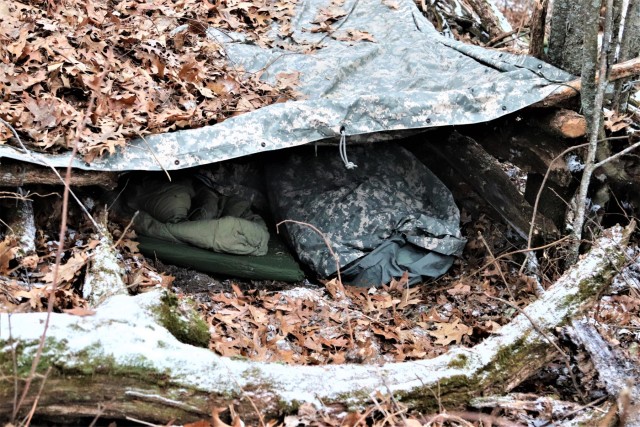 Cold-Weather Operations Course students build improvised shelters, survive outdoors