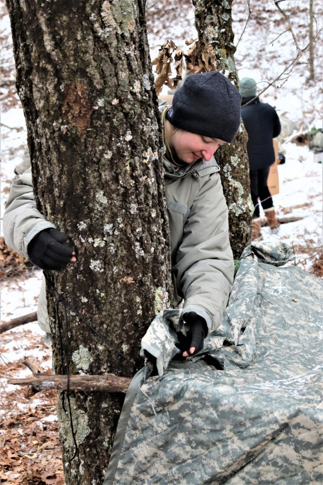 Cold-Weather Operations Course students build improvised shelters, survive outdoors