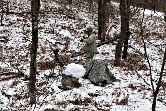 Cold-Weather Operations Course students build improvised shelters, survive outdoors