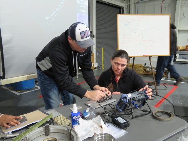 NDT technicians from Crane Army Ammunition Activity, Crane, Indiana, calibrate an eddy current test unit in preparation for testing during the hands-on portion of the NDT training conducted recently a