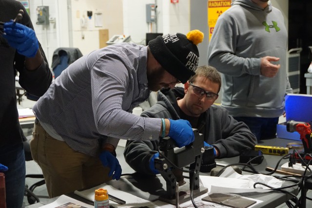 NDT technicians gain practical experience with magnetic particle testing, a non-destructive testing method, to determine if cracks, voids, or other issues exist with a weld during the hands-on portion