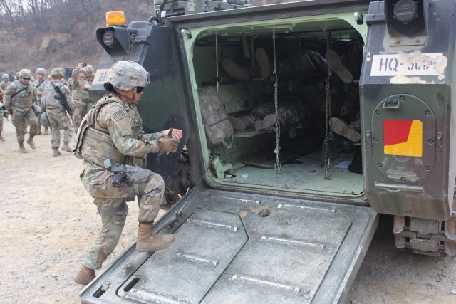 Soldiers unloading patients from M1A2 Abrams tanks