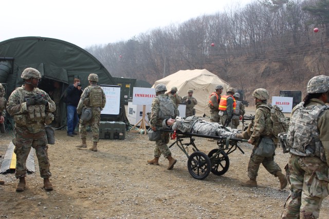 Soldiers transporting a patient to Emergency Medical Tent after triage