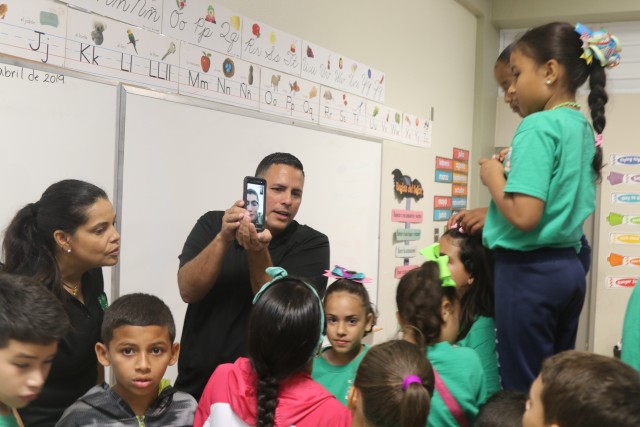 Puerto Rico Children talk with U.S. Soldier in Poland