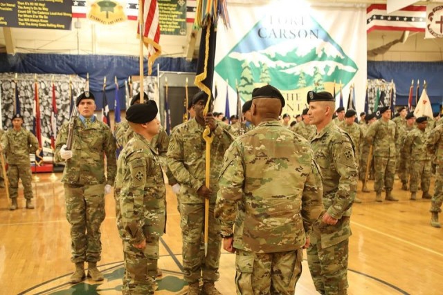 Command Sgt. Maj. Charles W. Tennant, Col. Monte Rone and Command Sgt. Maj. Delfin J. Romani, 1st Stryker Brigade Combat Team, 4th Infantry Division prepares to pass the organizational colors and res