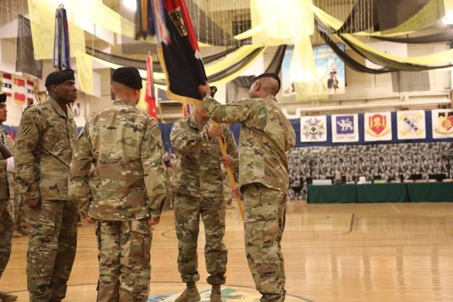 Command Sgt. Maj. Charles W. Tennant, Col. Monte Rone and Command Sgt. Maj. Delfin J. Romani, 1st Stryker Brigade Combat Team, 4th Infantry Division passes the organizational colors and responsibility