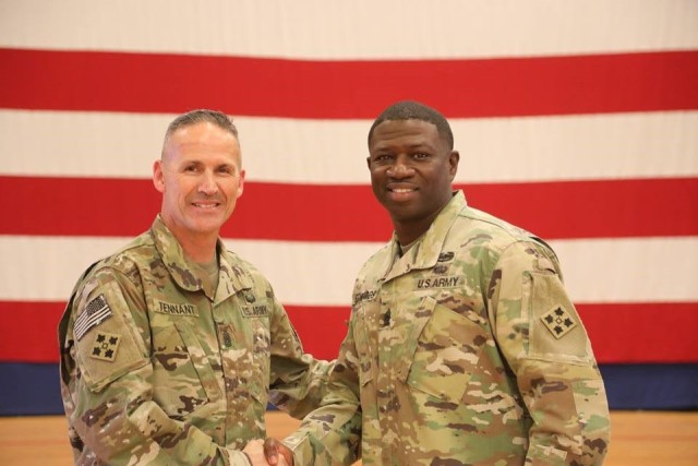 Outgoing Command Sgt. Maj. Charles W. Tennant, 1st Stryker Brigade Combat Team, 4th Infantry Division takes a picture with and buds farewell to Command Sgt. Maj. Jelani Edwards, 2nd Battalion 12th Fie