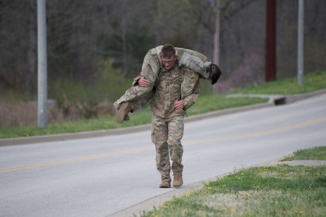 1st Lt. Jeremy Y. Matsumoto and Capt. Erwin J. Marciniak from 299 th Brigade Engineer Battalion, 1st Stryker Brigade Combat Team, 4th Infantry Division conduct a buddy carry exercise.