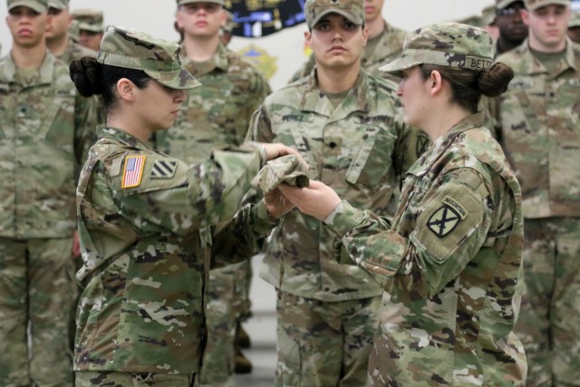 543rd Composite Supply Company cases their colors in preparation for their upcoming deployment to support Operation Atlantic Resolve