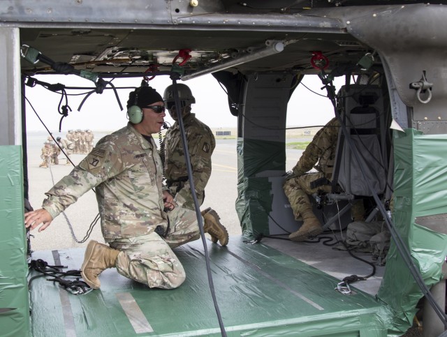 Service Members Participate in Helicopter Rappel and Sling Load Training