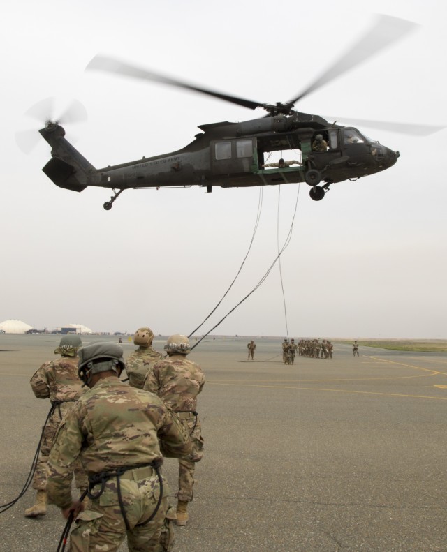 Service Members Participate in Helicopter Rappel and Sling Load Training