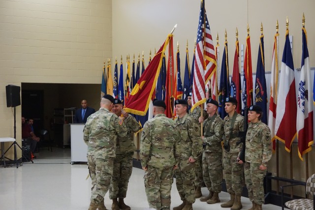 Lt. Col. Dennis Williams, left, receives the Letterkenny Munitions Center colors from Col. Michael Garlington, center, during the Change of Command Ceremony, June 6. The outgoing commander is Lt. Col.