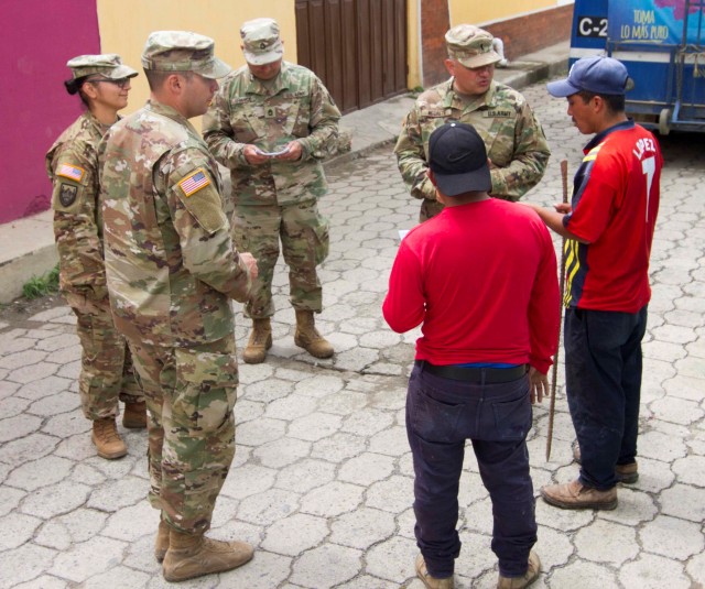 Soldiers visit local city to share information about a free medical event during annual training exercise