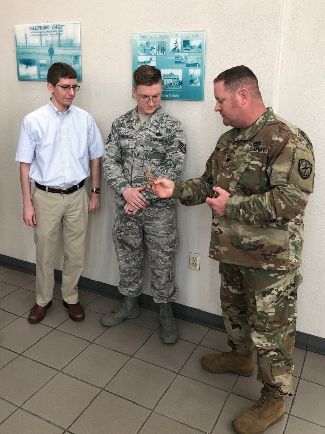 Army Cyber Command Soldiers present unit patches to seal partnership with Air Force cyber development organization