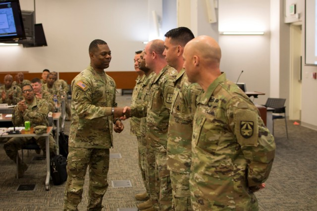 SGM Edward A. Bell, HQDA, G-4, presents coins of excellence at the 2019 HQDA G-4 Sustainment Senior Enlisted Leader Development Symposium.