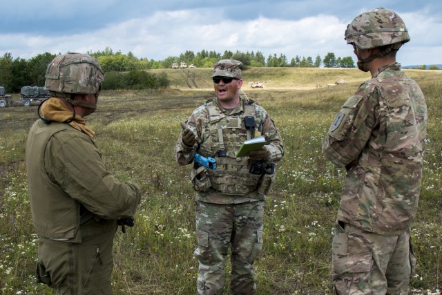 Sfc. Timothy Paddock, an Observer Controller Trainer (OCT) assigned to the Joint Multinational Readiness Center (JMRC) conducts an After Action Review (AAR) with the 1st Brigade 1st Infantry Division