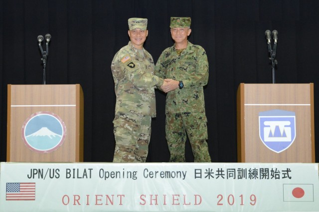 Commander of U.S. Army Japan and Commander of Western Army of the Japan Ground Self-Defense Force shake hands during opening ceremony of OS19