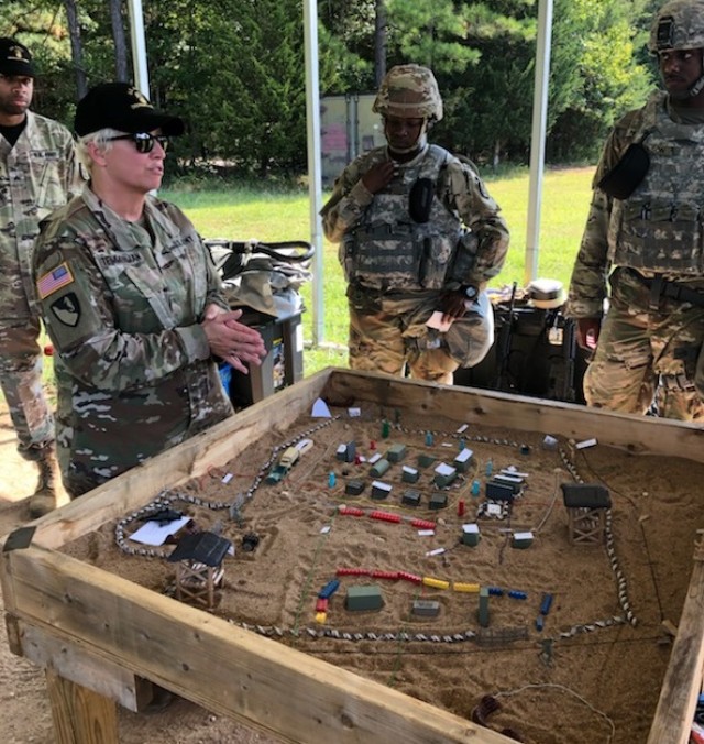 CW5 Pennie Temmerman talks with Ordnance Soldiers at the U.S. Army Ordnance Crucible's Ammunition Transfer Holding Point (ATHP) Team of the Year (ToY) event at Fort Pickett, Virginia.