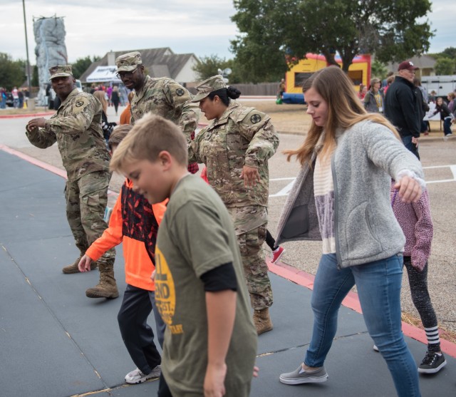 'Wolfpack' support students during fall festival, continue helping community