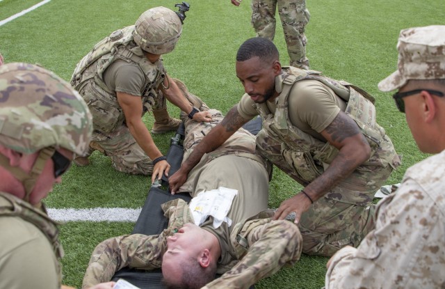 U.S. Army Soldiers roll a simulated casualty