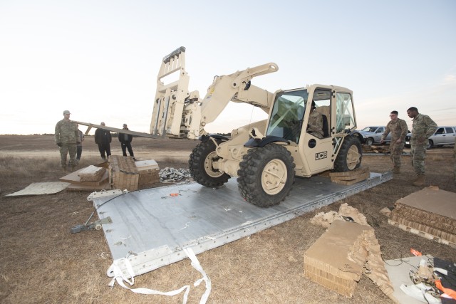 82nd Airborne Soldiers test forklift after cargo aircraft airdrop