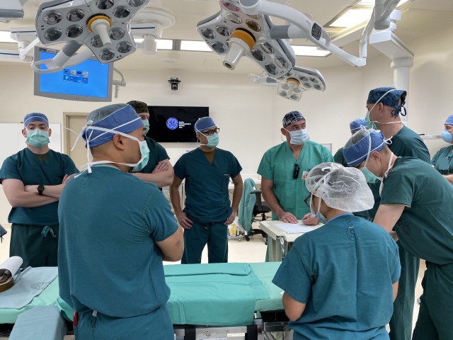 Tri-service surgeons have a huddle before starting OR day