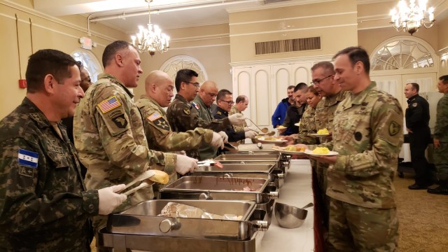 WHINSEC leadership serves Thanksgiving luncheon to International CGSOC faculty and students