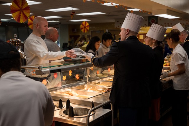 Commander and Mrs. Bundt serving