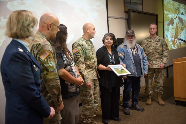 Senior leadership at the Presidio of Monterey and Defense Language Institute gift a photography to members of the Ohlone/Costanoan-Esselen Nation.