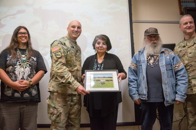 Senior leadership at the Presidio of Monterey and Defense Language Institute gift a photography to members of the Ohlone/Costanoan-Esselen Nation.