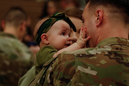 Six-month-old Emma reacts to seeing her dad, Spc. Jacob Debbery, Company B, 404 Aviation Support Battalion, 4th Combat Aviation Brigade, 4th Infantry Division, returning home from a deployment, following a homecoming ceremony at the William “Bill” Reed Center, Fort Carson, Colo., March 9, 2019. The 4th CAB deployed to Europe as part of the regionally allocated forces supporting Operation Atlantic Resolve. (U.S. Army photo by Sgt. Daphney Black)