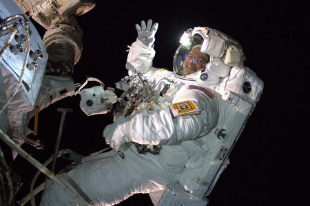 U.S. Army and NASA astronaut Andrew Morgan waves as he is photographed during an Extra Vehicular Activity, also known as a space walk, to install the International Space Station&#39;s second commercial crew vehicle docking port, the International...