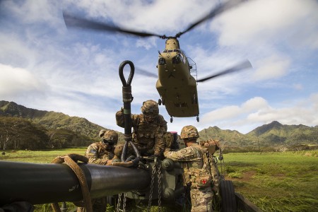 Soldiers prepare to sling load their M777 Howitzer onto a CH-47 Chinook helicopter during a two-gun raid air assault exercise Oct. 10, 2019 at Schofield Barracks, Hawaii. The coordinated exercise was the first live fire air assault of M777...