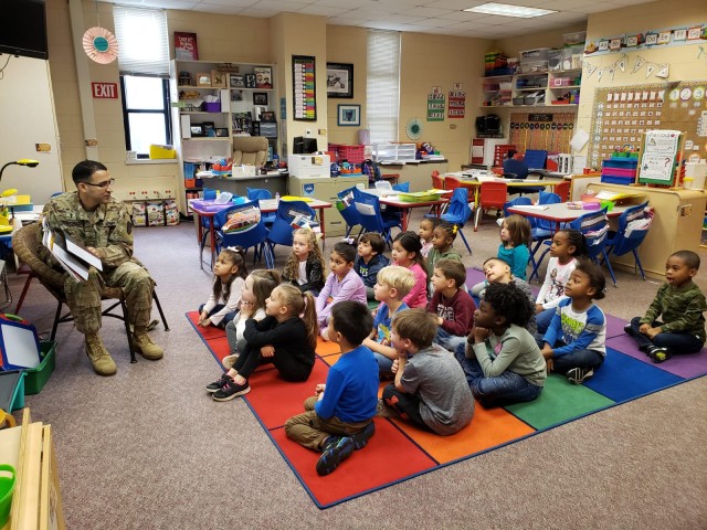 Chaplain Ismael Serrano reads to Kindergartens