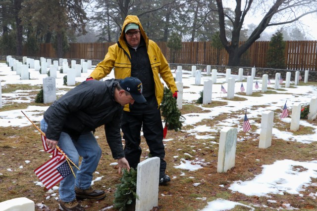 Community members place wreaths on veterans graves