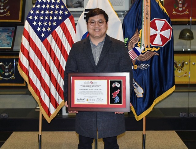 Posing with award