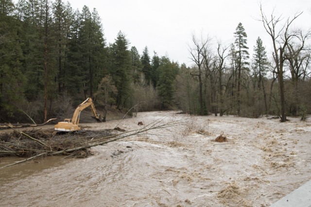 An excavator removes debris from the Mill Creek Channel