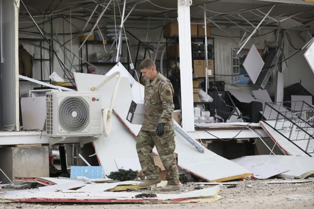 A U.S. airman searches for salvageable items after missile attacks at Al Asad Air Base, Iraq, Jan. 12, 2020.