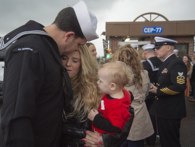 A sailor assigned to the Virginia-class, fast-attack submarine USS Washington greets his family at Naval Station Norfolk, Va., after a deployment, Feb. 11, 2020.