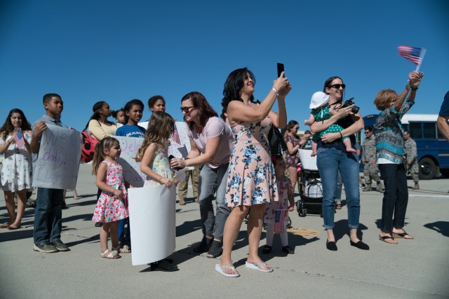 Family members prepare to greet deployed service members at March Air Reserve Base, Calif., Oct. 28, 2017.