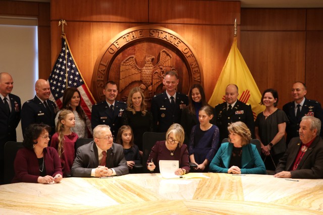 New Mexico Gov. Michelle Lujan Grisham signs HB 30 “Expedited Licensure for Military Families and veterans,” Feb. 26 at the state capitol. The legislation, the culmination of years of work to support reciprocity and ease of occupational licensing for military members, veterans and their families, is expected to come into effect July 1. Representatives from the state legislature, military installations in New Mexico, and civic leaders took part in the signing. 