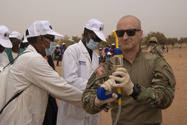 Army Maj. Kris Appler prepares a topical anti-parasitic medication that will be sprayed on more than 1,300 cattle in Kaedi, Mauritania, Feb. 23, 2020, during Flintlock 20. The annual international military and law enforcement exercise is focused on strengthening key partner-nation forces throughout North and West Africa.