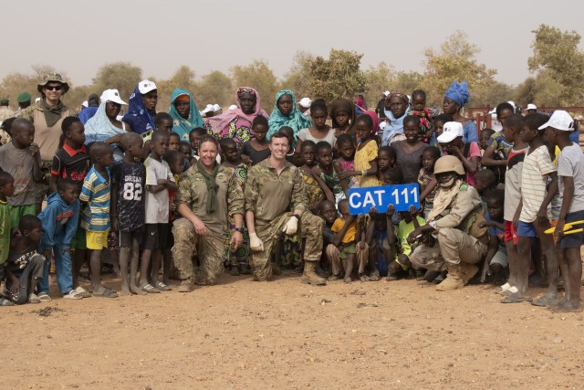 Soldiers pose with villagers after working with local veterinarians and ranchers to administer medication onto more than 1,300 cattle in Kaedi, Mauritania, Feb. 23, 2020, during Flintlock 20. The annual international military and law enforcement exercise is focused on strengthening key partner-nation forces throughout North and West Africa.