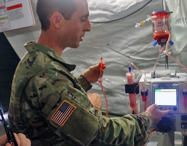 Extracorporeal Life Support test player preparing to connect the device to a simulated casualty.