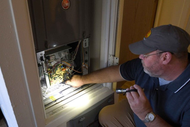 A member of the Fort Drum Residential Communities Initiative/Housing Division inspection team inspects a home at Fort Drum, N.Y. The team averaged 11 to 14 home inspections a day during the peak summer moving season.