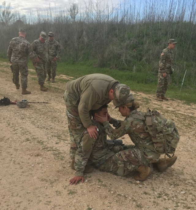 Medics work a patient in the field
