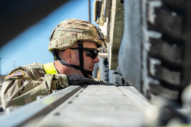 Staff Sgt. Mark Dewese, Headquarters and Headquarters Company, 1st Cavalry Division Sustainment Brigade, ties down a vehicle to a trailer during line-haul operations at Fort Hood, Texas. The line-haul operations are in preparation of exercise Defender-Europe 20, the deployment of a division-size combat-credible force from the United States to Europe.